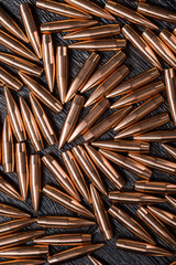 Placer copper bullets on a dark wooden background