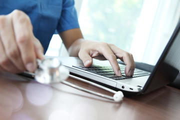 Fototapeta premium Doctor working with laptop computer in medical workspace office