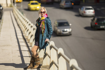 Fototapeta na wymiar Young fashion woman standing on city street.