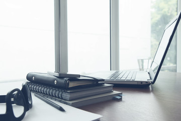 Office workplace with laptop and smartphone on wood table
