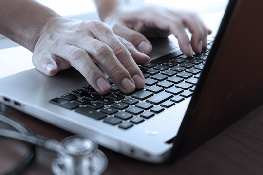 close up of Doctor hand using laptop computer in office