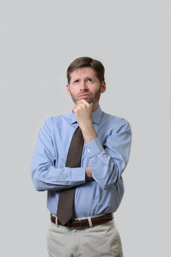 Business man with quizzical look and arms crossed