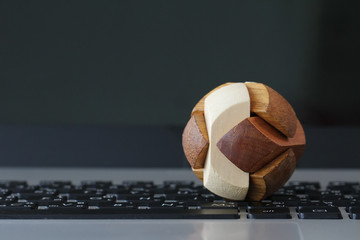 wooden texture globe with social media diagram on laptop compute