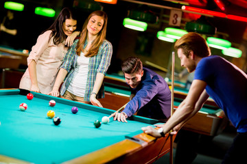 Young people playing pool