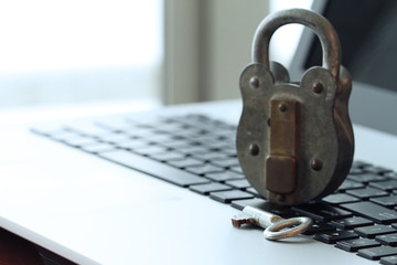 Internet security concept-old padlock and key on laptop computer