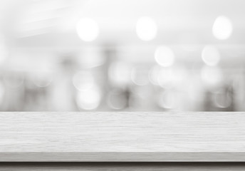 Empty wood table and blurred cafe with bokeh light background