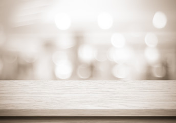Empty wood table and blurred cafe with bokeh light background