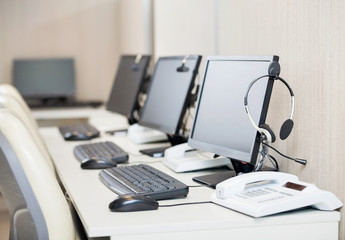 Computers With Headphones At Workplace