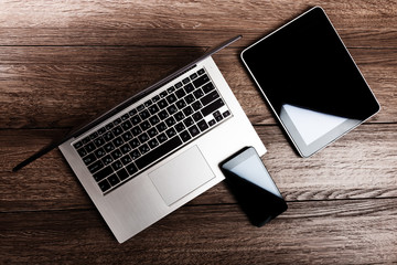 keyboard with phone and tablet pc on wooden desk