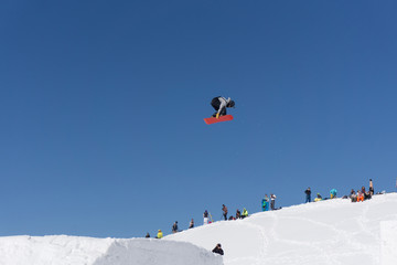 Naklejka na ściany i meble Snowboarder jumps in Snow Park