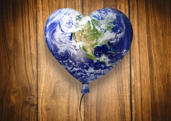 Composite image of heart shaped earth