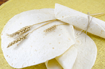 Bunch of tortillas and a stick of wheat