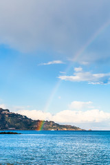 Taormina cape and rainbow in Ionian Sea in spring
