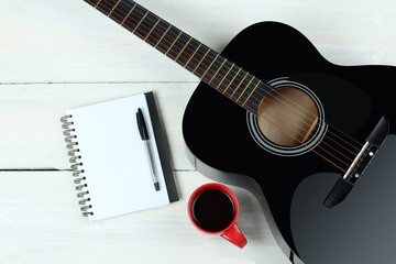 Fototapeta premium Acoustic guitars with a cup of coffee on wood background