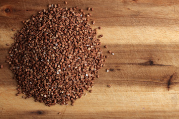 Grains of buckwheat on the kitchen board