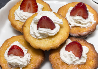 Cupcakes with whipped cream, strawberries