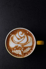 Cup of cappuccino on dark background. Top view