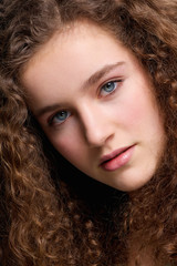 Beauty portrait teenage female fashion model with curly hair