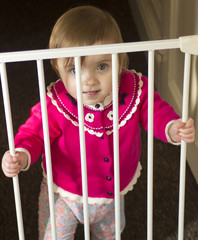 baby stood near baby gate