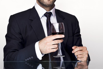 Businessman holding a glass of red wine