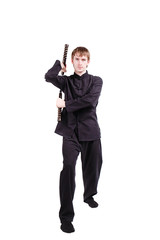 Obraz premium Man in a kimono practicing kung fu with nunchaku