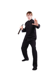 Man in a kimono practicing kung fu with nunchaku