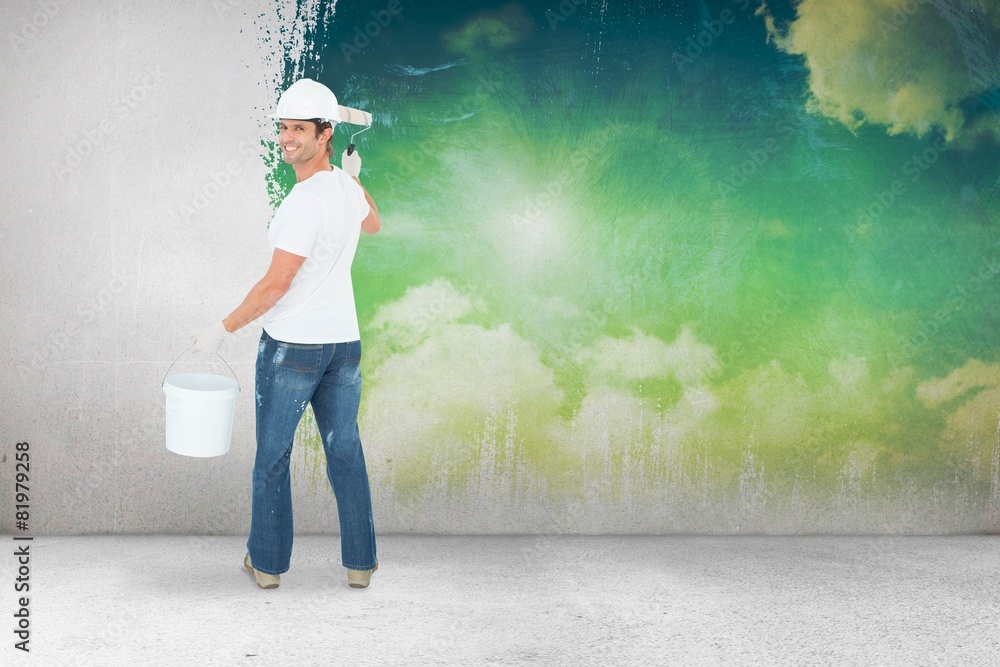 Aufkleber Composite image of happy man using paint roller