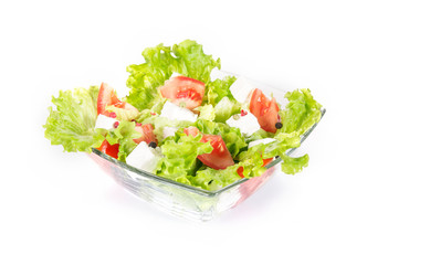 Green salad with tomato and cheese in a bowl