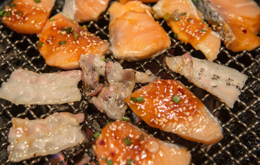 Korean style grilled salmon fish and meat closeup