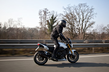 Fototapeta premium Motorcyclist biker on the road