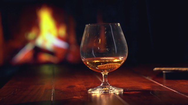 Cognac. Pouring Brandy from a Bottle to a Glass