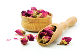 Buds of dried roses for tea in a wooden bowl
