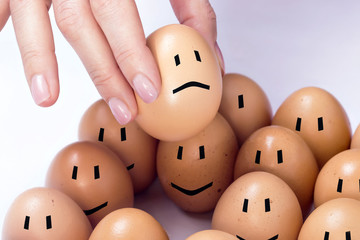 An egg selected among others, feeling sad