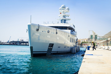 Luxury yacht docking at port.