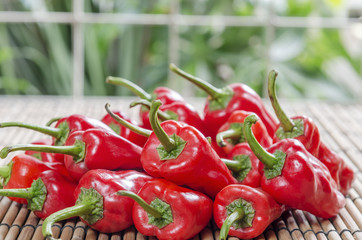 fresh red chilies on wooden bamboo display