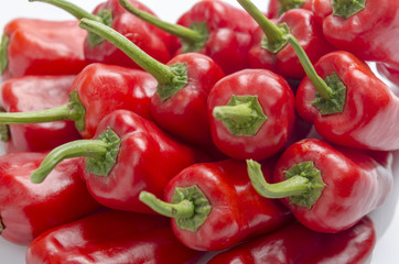 fresh red chilies on white background display