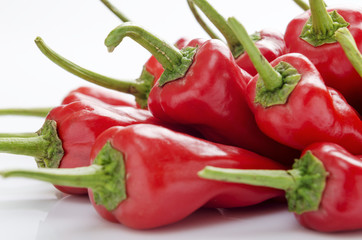fresh red chilies on white background display