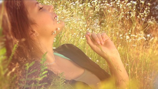 Beautiful Girl Lying on the Meadow and Dreaming