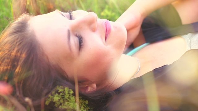 Beautiful Girl Lying on the Meadow and Dreaming