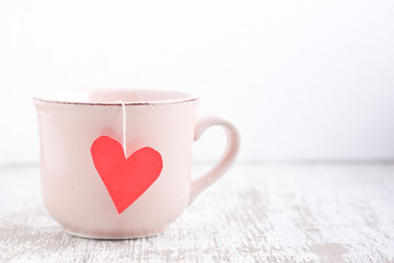 cup with heart shape tea bag