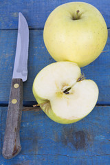 apples and knife on wood