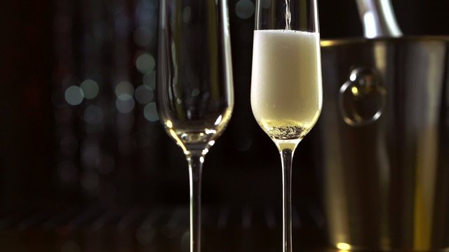 Flutes with sparkling champagne closeup. Slow motion