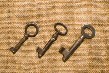 A lot vintage keys on old cloth