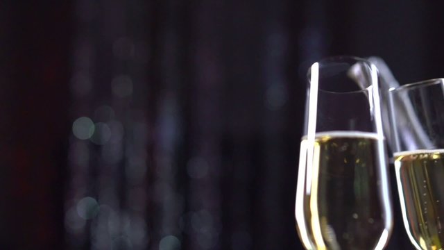 Two Glasses with Sparkling Champagne. Slow motion