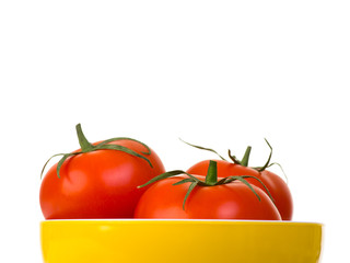 Tomatoes in yellow to view bowl isolated