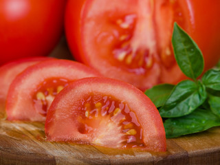 Tomatoes extreme close-up presentation sliced on wooden plank