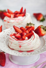 Pavlova meringue cake decorated with fresh strawberry