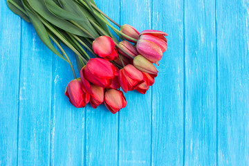 Fresh tulips arranged on old wooden background with copy space