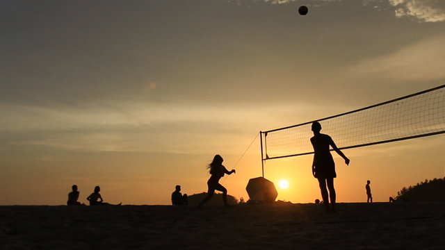 Beach volleyball at sunset time