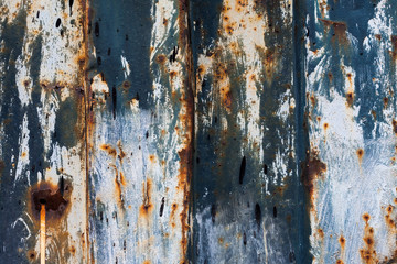 red rust on the color metal wall with planks. background,Texture